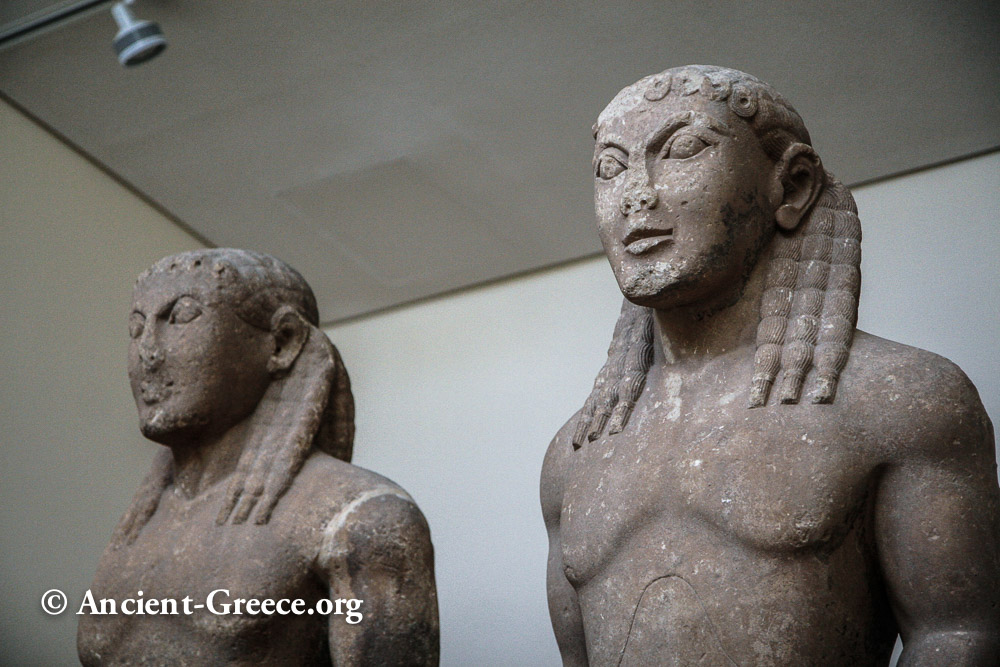 Closeup of two kouros statues