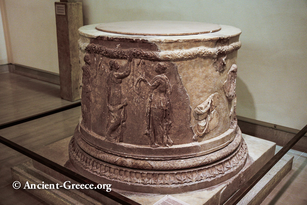 Cylindrical altar with relief sculptures