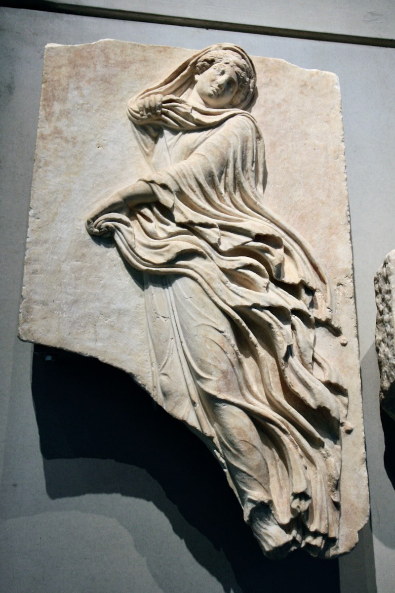 Marble relief slab depicting a dancer