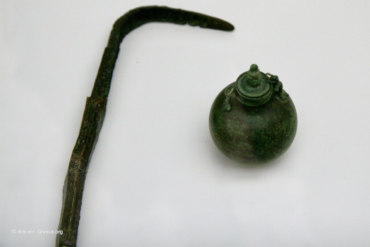 Bronze strigil and aryballos (oil