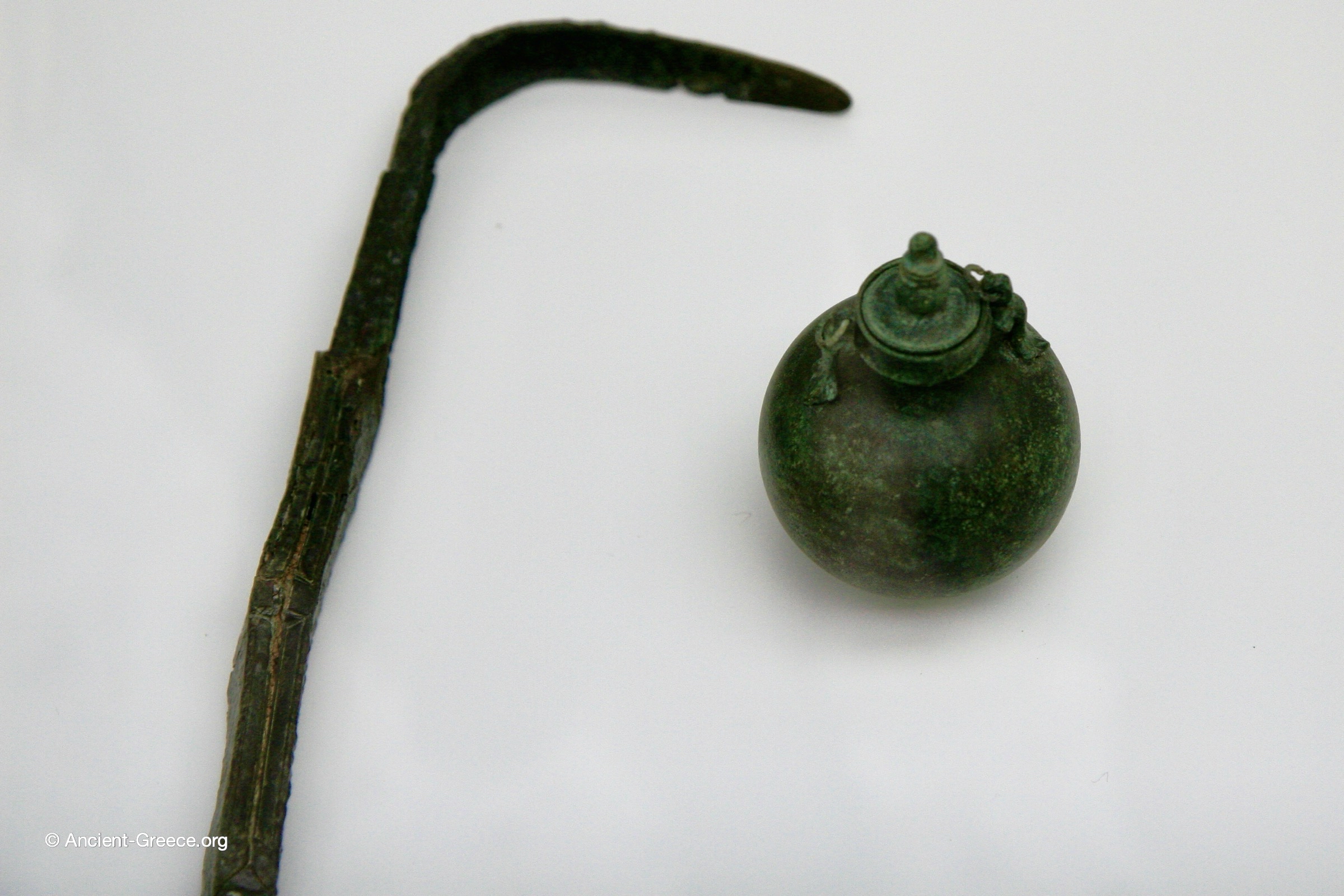 Bronze strigil and aryballos (oil