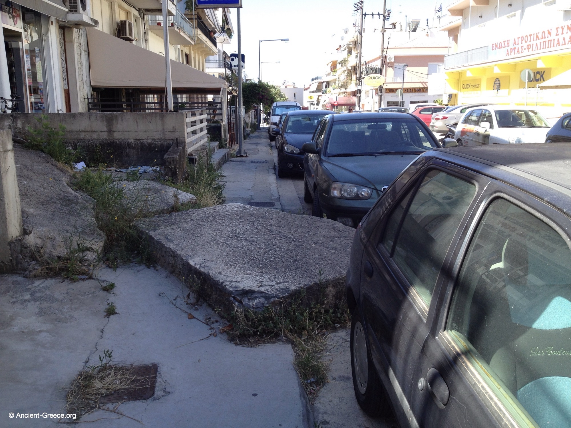 The Temple of Apollo Pythios stones gasping for air in the modern sea of cement