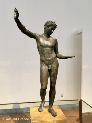 Bronze statue of a youth studying an object