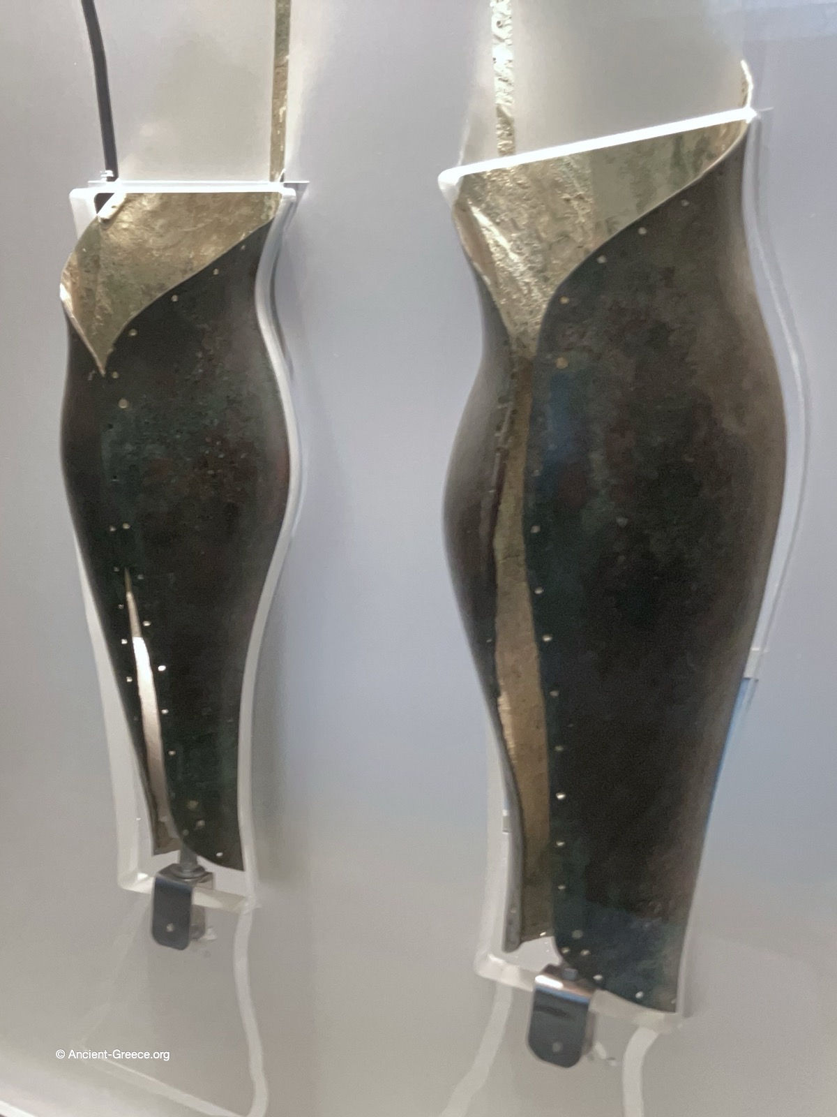 Ancient Greek bronze greaves. Back view. . Hoplite armor.