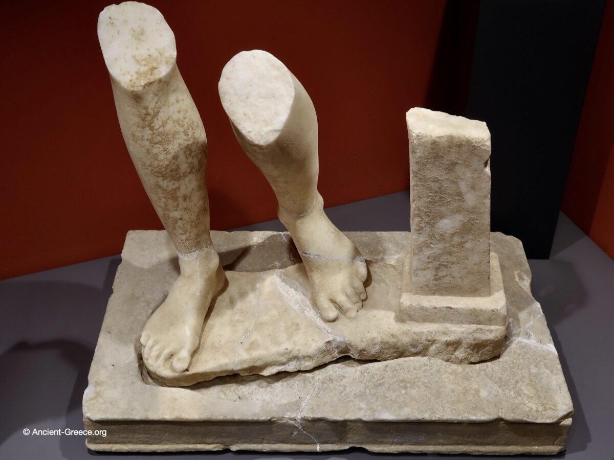 Marble statue fragment of lower legs.