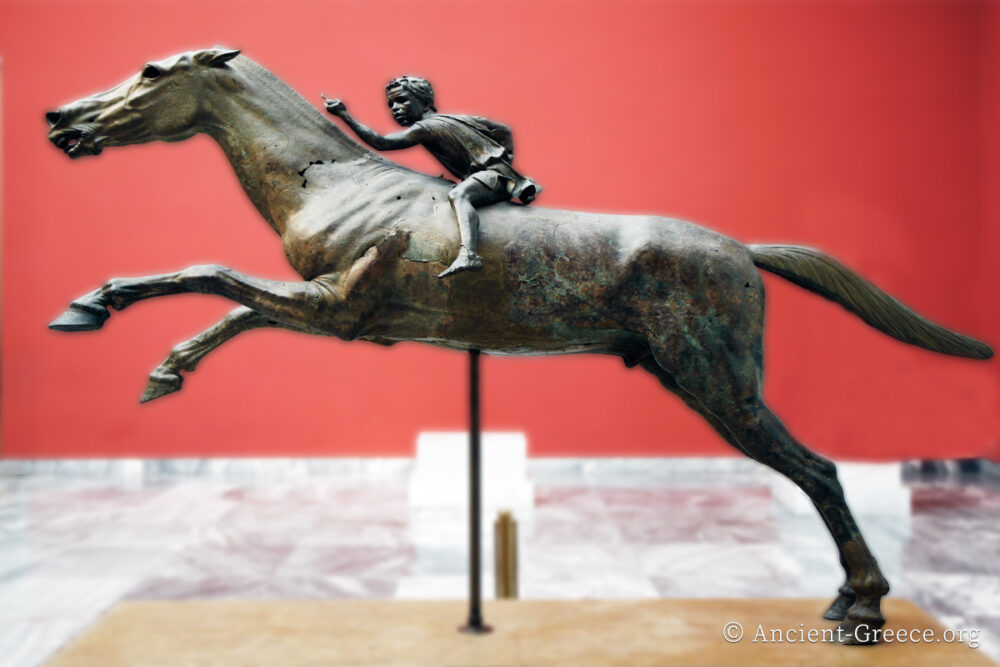 Horse and Jockey Bronze statue of a young jockey on a leaping horse.