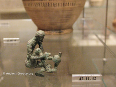 Statuette of a bronze armorer working on a helmet