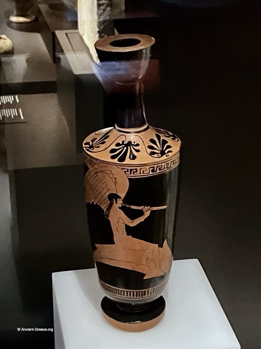 Eros riding a dolphin. on a lekythos pottery