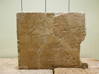Grave stele with bull hunt incised.