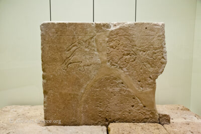 Grave stele with bull hunt incised.