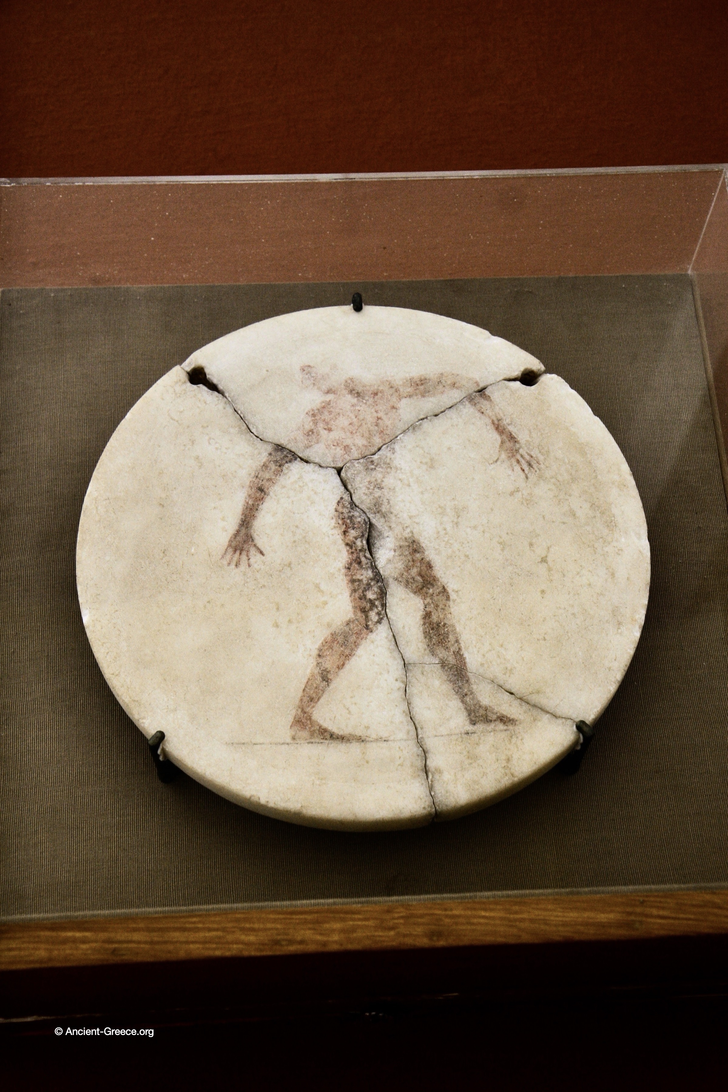 Marble disk, depicting a discus thrower.