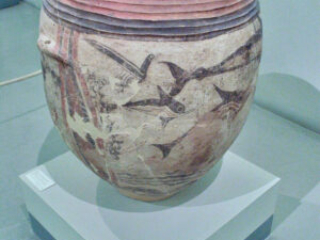 Ceramic vessel with birds and dolphins.