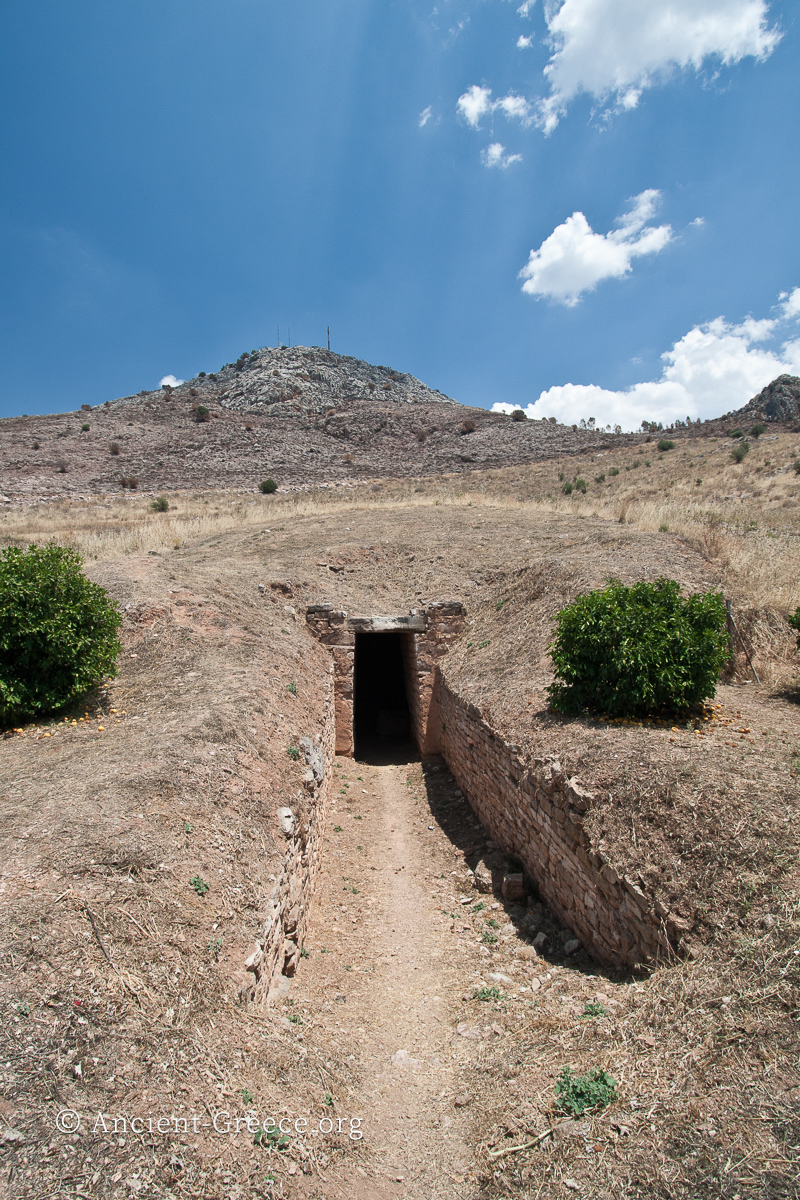 Tiryns tholos tomb with its Dromos (entryway) the Stomion (door that was blocked with rocks), and the soil that covers the corbel grave chamber.